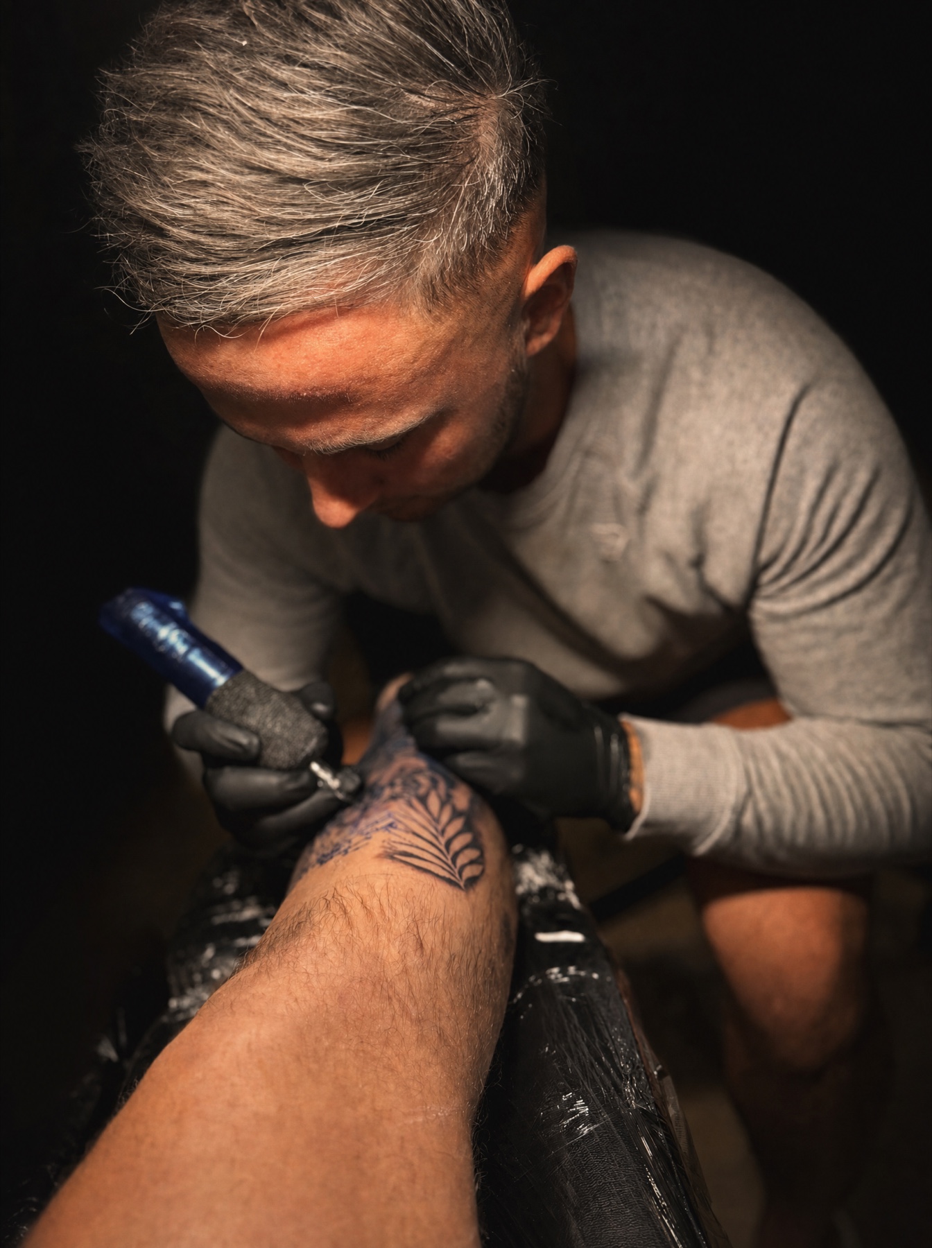 Ollie Hall tattooing in his Middleton studio