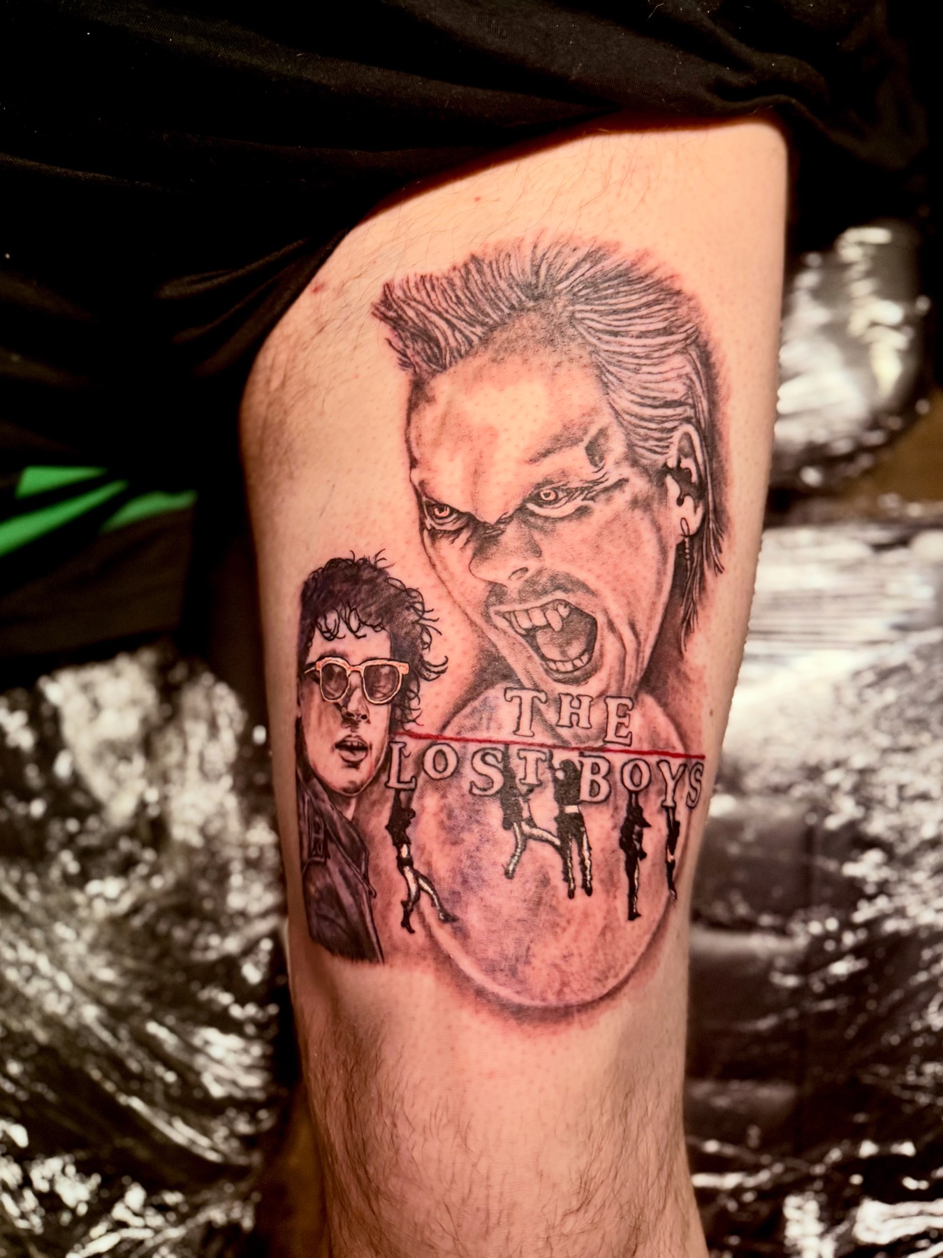 Black and grey tattoo of The Lost Boys film characters on a thigh