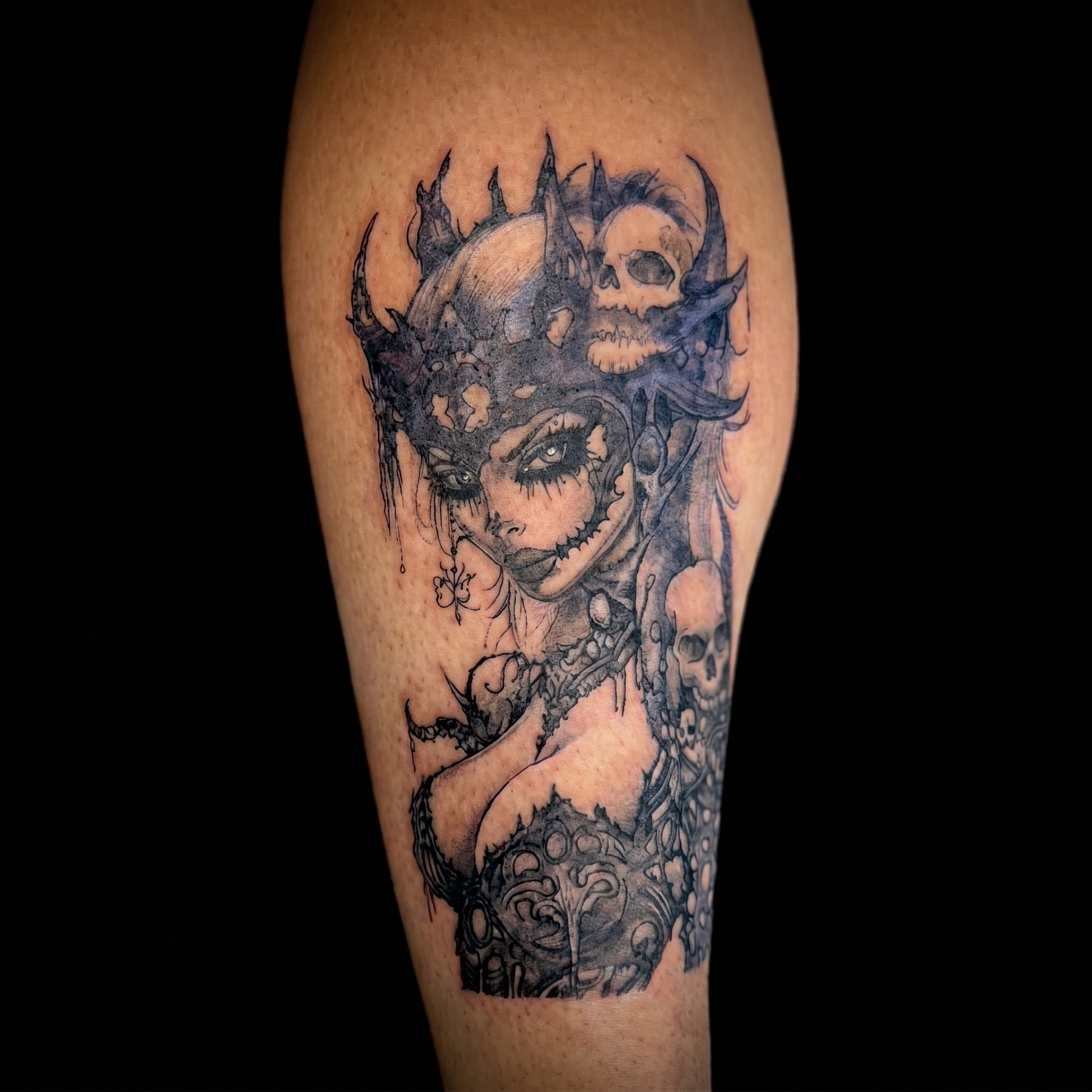 Black and grey female warrior portrait tattoo on an arm